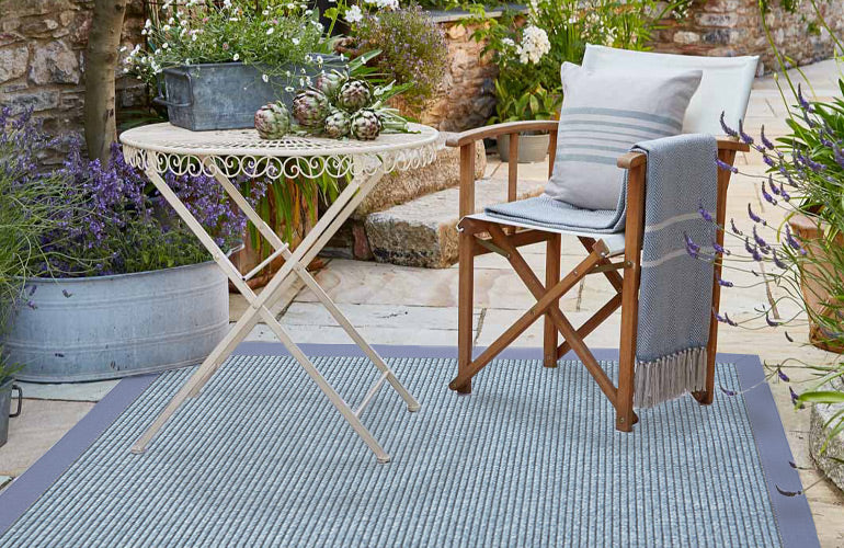 Complete al fresco dining with a waterproof outdoor rug